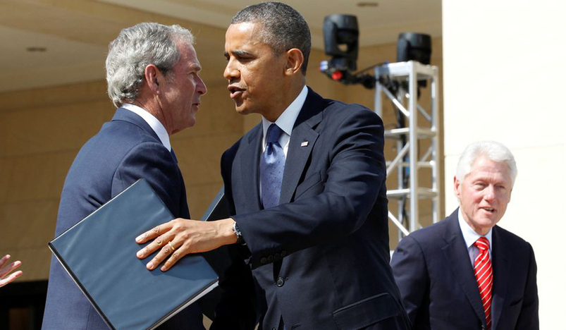 U.S. President Barack Obama embraces former President George W. Bush